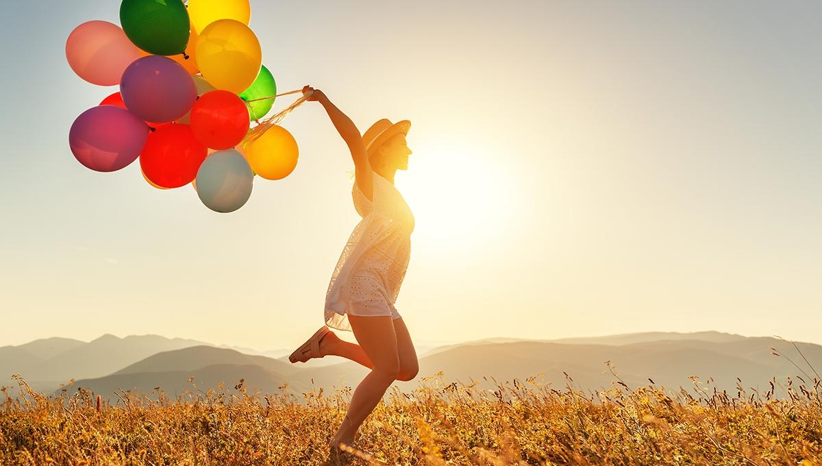 Article Cards Featured Image happy woman with balloons at sunset in summer