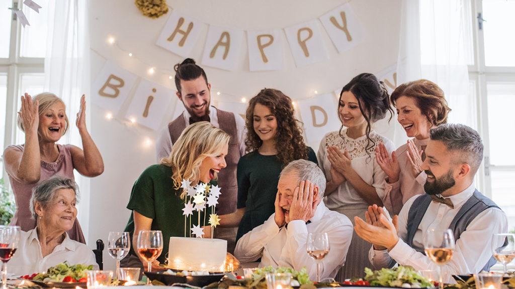 march birthdays A senior man with multigeneration family celebrating birthday on indoor party.